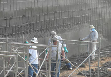 KIA Contractors shotcrete crew in full PPE on a jobsite